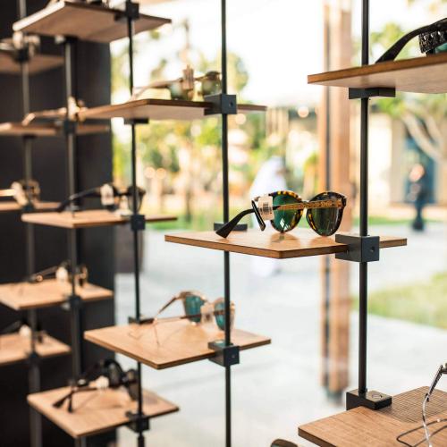 Sky Line - shop window display with aluminium rod construction and wooden side shelves.