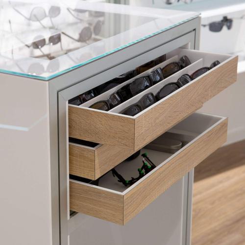 Acrylic showcase table with glass top and wooden removable trays.