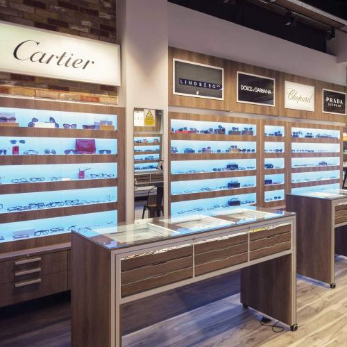 Traditional wall display cabinets with wooden decor for a UK based optician.